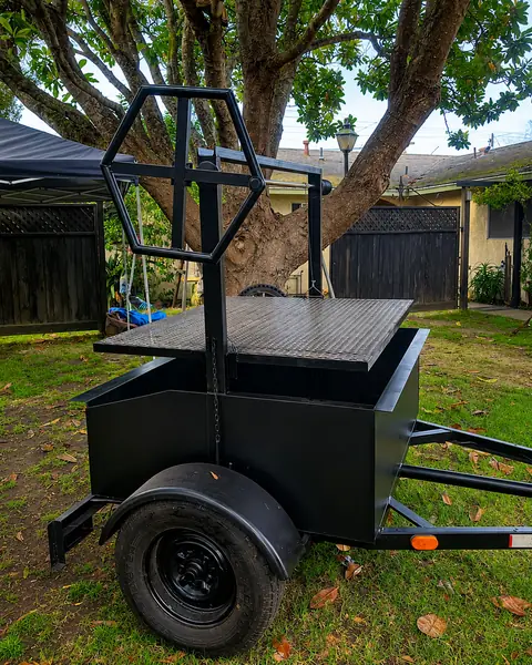 The Oak & Ember Santa Maria grill trailer under an oak tree