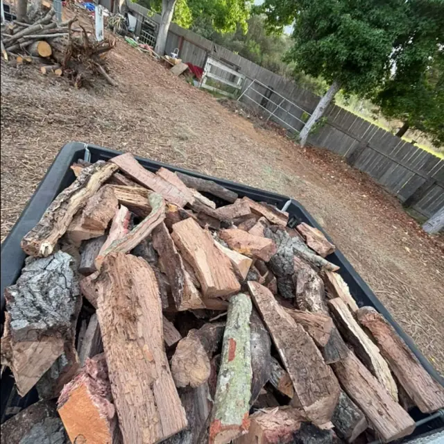 Split red oak stacked in a truck bed